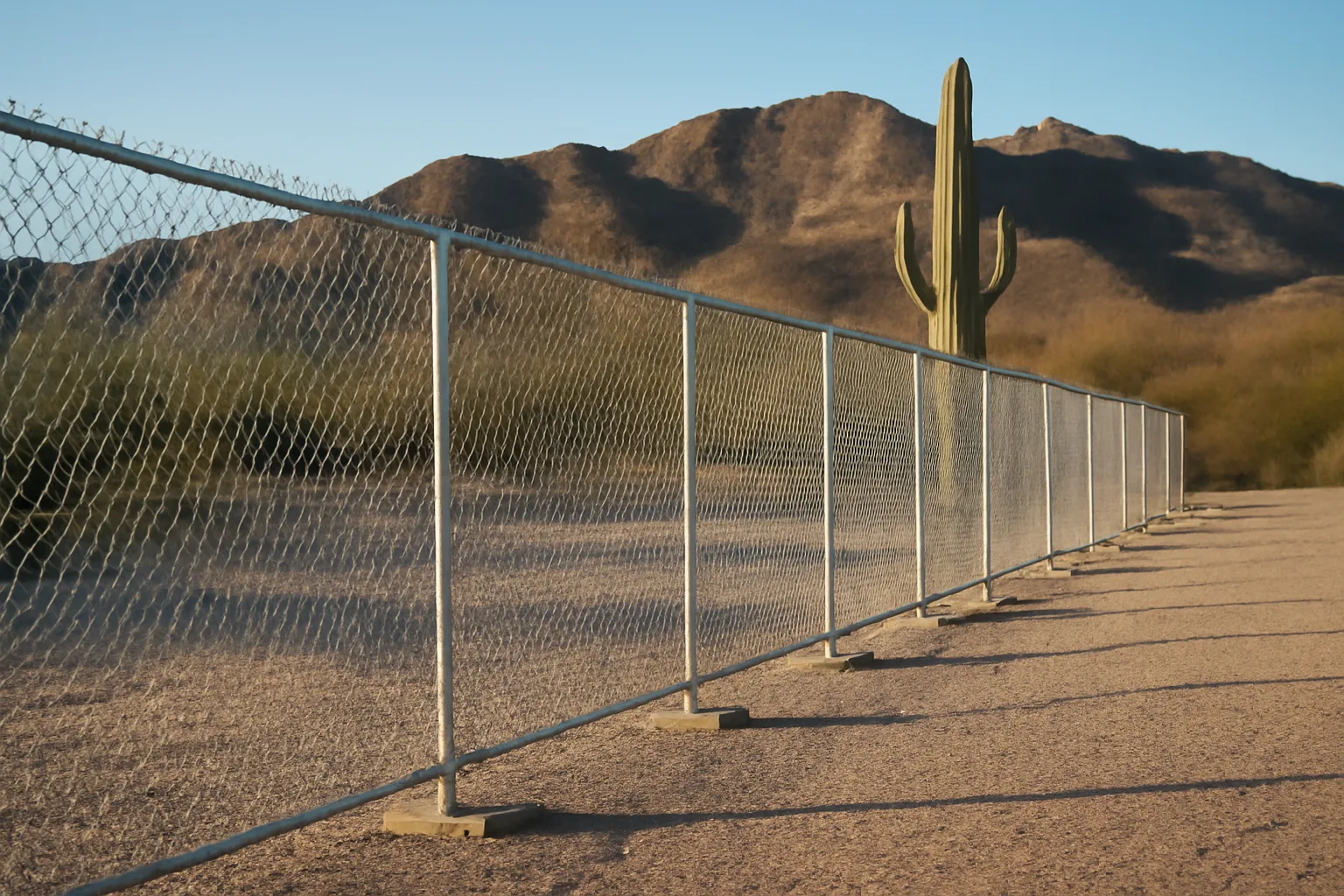 Galvanized temp fence panels standing in desert gravel near Phoenix
